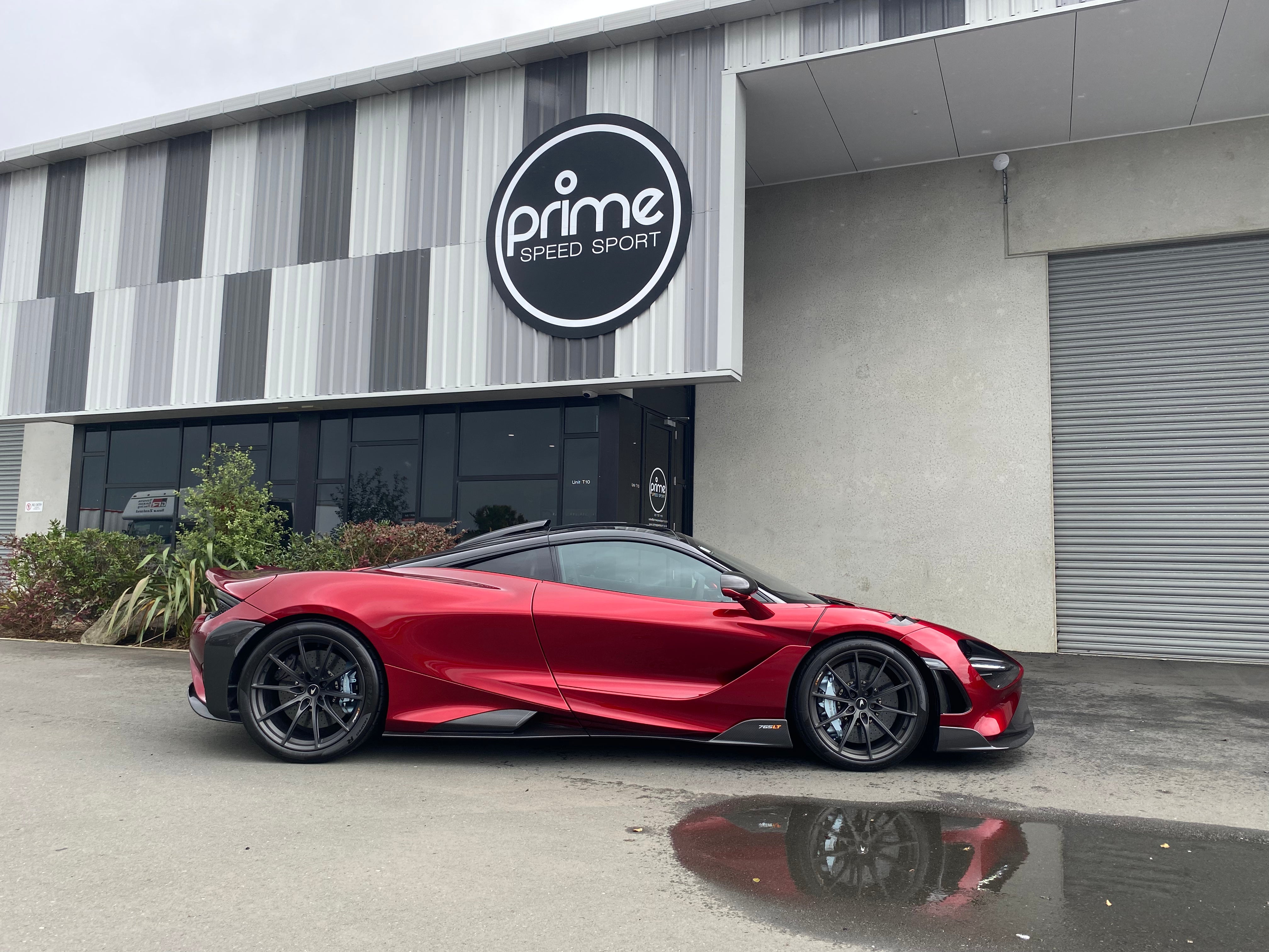 Side view of a 2021 McLaren 765LT For Sale by Prime Speed Sport in New Zealand. Highly specced with full carbon pack and finished in MSO optioned Volcano Red exterior paint.