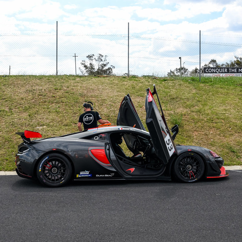 Black and Red McLaren 570 GT4 at Challenge Bathurst at Mount Panorama