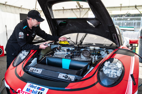 Image of Prime Speed Sport Personnel working on a Porsche 911.2 GT3 R at a race weekend.