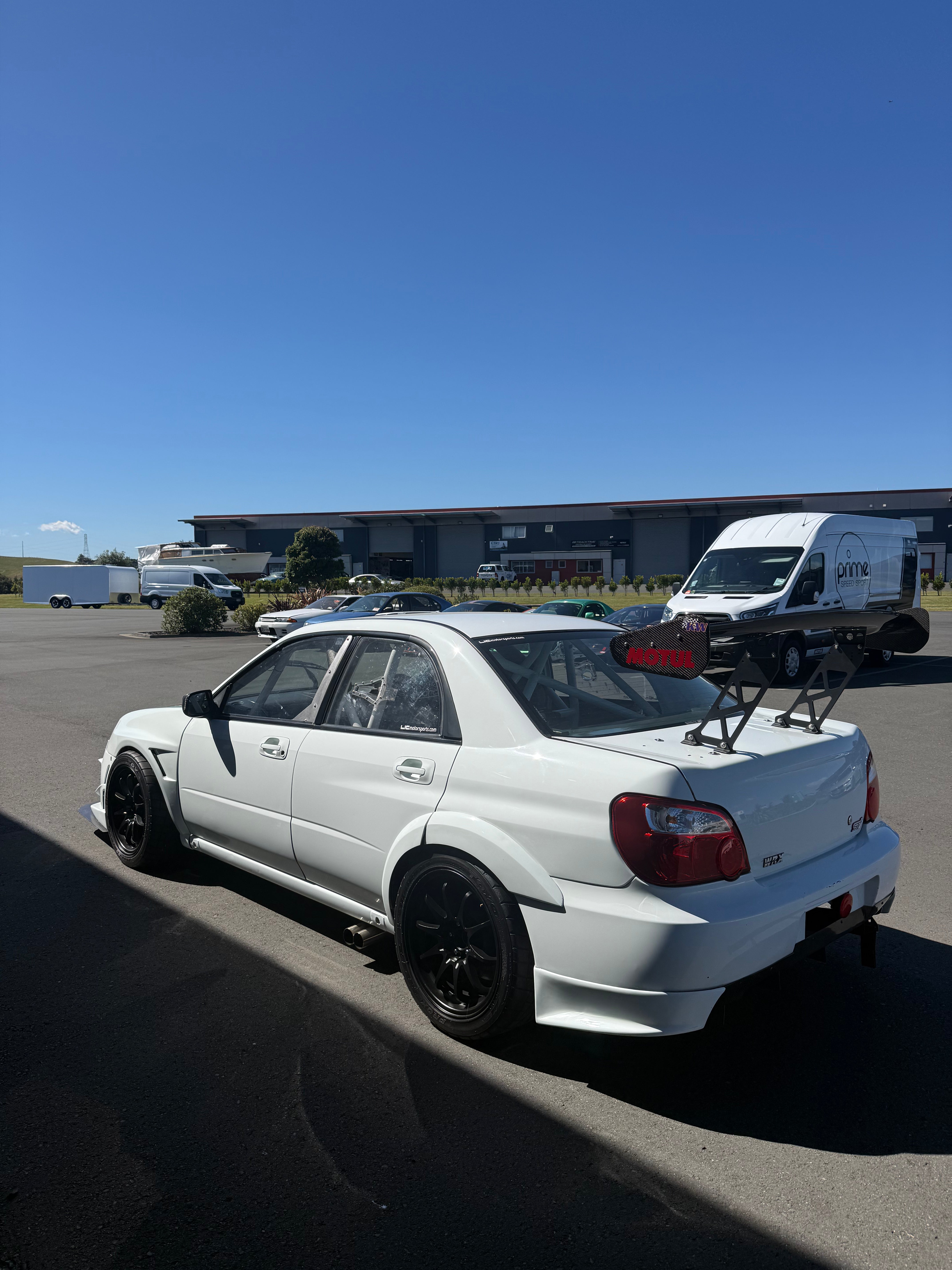 Side View of a Subaru Impreza at Prime Speed Sport with a clear day 
