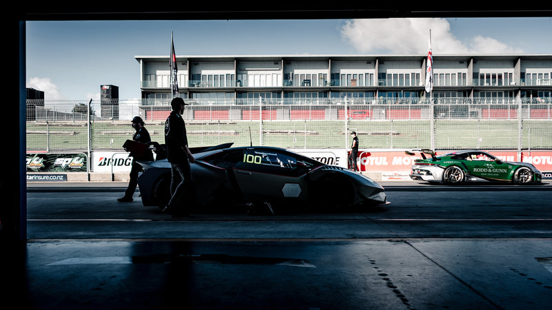 Porsche 911 Cup Car and Lamborghini Super Trofeo in the Pit Lane of Hampton Downs International Motorsport Park along side Race Mechanics
