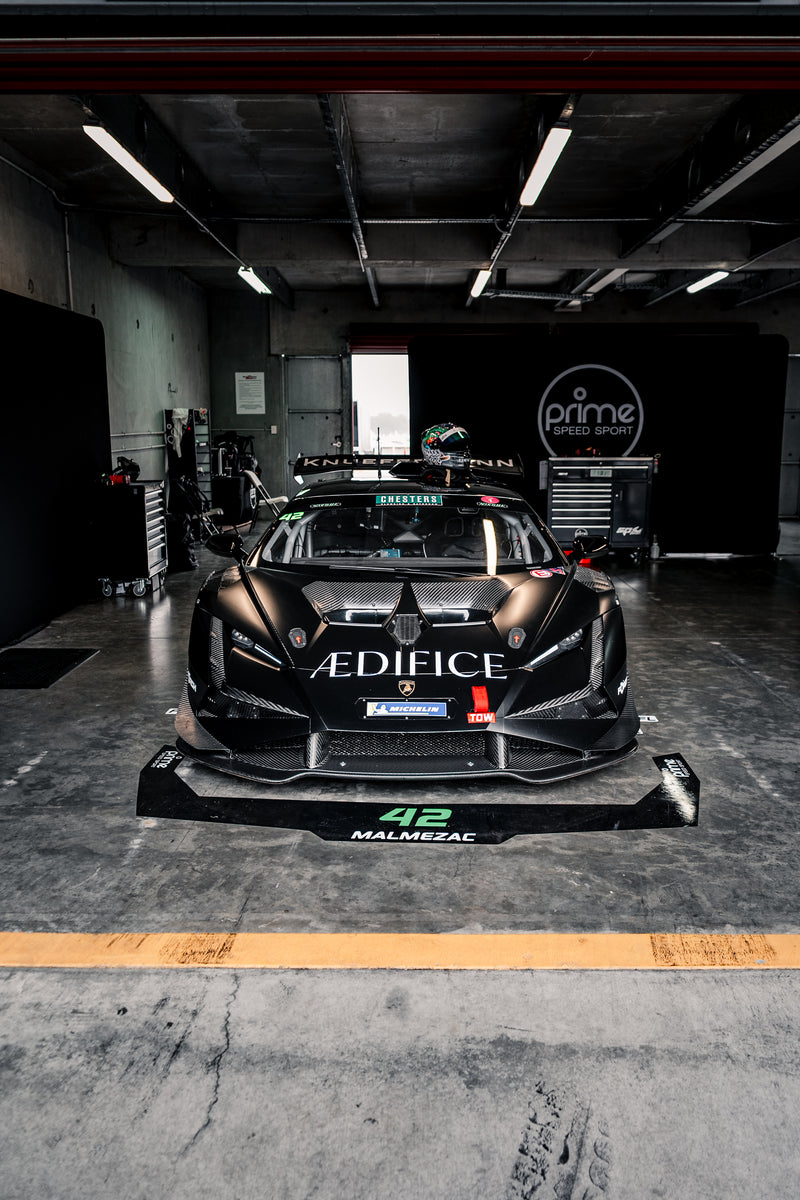 Black Lamborghini Super Trofeo Evo 2 inside a Prime Speed Sport Garage at the North Island Endurance Championship 2025. Sponsored by Aedifice and Knuffermann. 