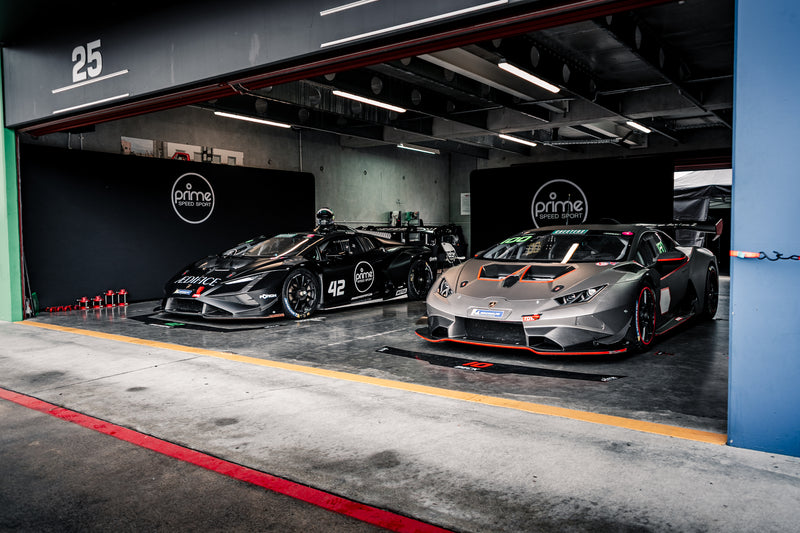 Two Lamborghini Super Trofeos, one Super Trofeo Evo 1, and one Super Trofeo Evo 2, in a Prime Speed Sport garage at Hampton Downs Motorsport Park