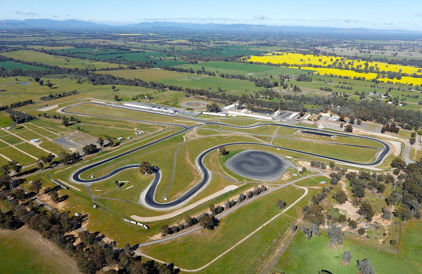 Aerial view of Winton motor racing race track surrounded by green fields and trees